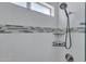 The updated shower features new fixtures, subway tiling, and sleek shelving at 14145 N 92Nd St # 2046, Scottsdale, AZ 85260