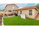 Spacious backyard featuring lush artificial grass and an inviting patio seating area at 1557 S Halsted Dr, Chandler, AZ 85286