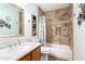 Well-maintained bathroom featuring tiled walls, a shower and tub, and a classic vanity at 1557 S Halsted Dr, Chandler, AZ 85286