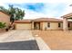 Charming single-story home featuring a low-maintenance front yard, two-car garage and covered porch at 1557 S Halsted Dr, Chandler, AZ 85286