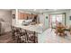 Bright kitchen with breakfast bar island, stainless appliances, tile floors, and outdoor access at 1557 S Halsted Dr, Chandler, AZ 85286