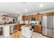Bright, eat-in kitchen featuring stainless steel appliances and an island with granite countertops at 1557 S Halsted Dr, Chandler, AZ 85286