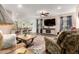 Cozy living room seamlessly flowing into the kitchen and dining area, with a ceiling fan and patterned rug at 1557 S Halsted Dr, Chandler, AZ 85286
