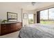 Cozy bedroom with large windows, a corner view, and a dresser with a decorative mirror at 15802 N 71St St # 311, Scottsdale, AZ 85254