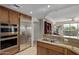 Gourmet kitchen featuring stainless steel appliances, double ovens, granite counters, and breakfast bar seating at 15802 N 71St St # 311, Scottsdale, AZ 85254