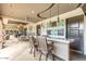 Inviting outdoor lounge area features a marble counter, bar seating, and modern pendant lighting at 15802 N 71St St # 311, Scottsdale, AZ 85254