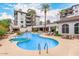 Luxury resort-style pool with spa, lounge chairs, and shaded seating areas for relaxation at 15802 N 71St St # 311, Scottsdale, AZ 85254