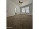 Carpeted bedroom featuring a ceiling fan and a doorway to the bathroom at 1620 E Jacinto Ave, Mesa, AZ 85204