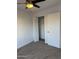 Bedroom with carpet, ceiling fan, closet, and door at 1620 E Jacinto Ave, Mesa, AZ 85204