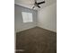 Cozy carpeted bedroom with a bright window allowing natural light to fill the space at 1620 E Jacinto Ave, Mesa, AZ 85204