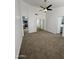 Carpeted bedroom with fan has doors to kitchen and bath for convenience at 1620 E Jacinto Ave, Mesa, AZ 85204