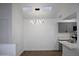 Open dining area featuring stylish light fixture, skylights, and gray cabinets at 1620 E Jacinto Ave, Mesa, AZ 85204