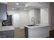 Bright kitchen showcasing stainless appliances, a modern faucet, quartz countertops, and skylights at 1620 E Jacinto Ave, Mesa, AZ 85204