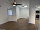 Open-concept living room with high ceilings, skylights, ceiling fan, and view into the kitchen at 1620 E Jacinto Ave, Mesa, AZ 85204