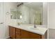 Bathroom with double sink vanity, large mirror, and a combination bathtub and shower at 16238 N 22Nd Ln, Phoenix, AZ 85023