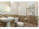 Half bathroom featuring mosaic tile accent wall, pedestal sink, and natural light at 16238 N 22Nd Ln, Phoenix, AZ 85023
