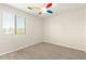 Bedroom featuring neutral carpet, a large window, and bright light fixture at 16238 N 22Nd Ln, Phoenix, AZ 85023