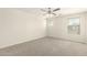 Bedroom features neutral carpet, multiple windows, and a modern ceiling fan at 16238 N 22Nd Ln, Phoenix, AZ 85023