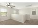 Bright bonus room featuring neutral carpet, multiple windows, and a modern ceiling fan at 16238 N 22Nd Ln, Phoenix, AZ 85023