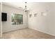 Empty dining room with tile floors, a modern chandelier, and ample natural light at 16238 N 22Nd Ln, Phoenix, AZ 85023