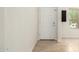 Bright entryway with neutral tile flooring leading to a white interior door and light-filled room at 16238 N 22Nd Ln, Phoenix, AZ 85023