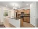 Bright kitchen with tile flooring, kitchen island, stainless steel appliances, and wood cabinetry at 16238 N 22Nd Ln, Phoenix, AZ 85023