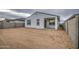 Unfinished backyard features a stucco home exterior with a covered patio and block wall fencing at 17567 W Adams St, Goodyear, AZ 85338