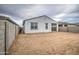 Wide backyard offers potential, showing the stucco exterior and block wall fence. Awaiting personalization at 17567 W Adams St, Goodyear, AZ 85338