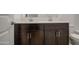 Bathroom with a double sink vanity featuring dark wood cabinets and white countertops at 17567 W Adams St, Goodyear, AZ 85338