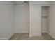 Neutral bedroom featuring plush carpet, a closet, and a standard door at 17567 W Adams St, Goodyear, AZ 85338