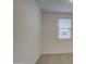 Neutral carpeted bedroom with a window providing natural light at 17567 W Adams St, Goodyear, AZ 85338