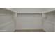 Walk-in closet with shelving and racks installed for organized storage at 17567 W Adams St, Goodyear, AZ 85338