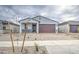 Single-Gathering home with desert landscaping, a brick driveway, and an attached garage at 17567 W Adams St, Goodyear, AZ 85338