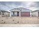 Home with modern design, a brick driveway, and desert landscaping at 17567 W Adams St, Goodyear, AZ 85338