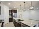 Spacious kitchen island featuring stainless steel appliances, granite countertops, and modern pendant lights at 17567 W Adams St, Goodyear, AZ 85338