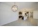 Open-concept kitchen with dark cabinets, granite countertops, and a large island that opens to the living area at 17567 W Adams St, Goodyear, AZ 85338