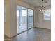 View of a living area with sliding glass doors and modern lighting fixture at 17567 W Adams St, Goodyear, AZ 85338