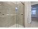 Modern shower features a sliding glass door, tile surround and wood-look flooring at 17567 W Adams St, Goodyear, AZ 85338