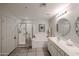 Bathroom featuring walk-in shower, soaking tub, double sinks and large mirror at 19700 N 76Th St # 1124, Scottsdale, AZ 85255