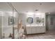 Bright bathroom featuring walk-in shower, soaking tub, double sinks and large mirrors at 19700 N 76Th St # 1124, Scottsdale, AZ 85255