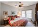 This bedroom features warm lighting, two windows, and a ceiling fan at 19700 N 76Th St # 1124, Scottsdale, AZ 85255