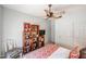 This bedroom features a ceiling fan, white closet doors, and a bookshelf at 19700 N 76Th St # 1124, Scottsdale, AZ 85255