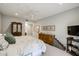 Well-lit bedroom with patterned bedding, wood furniture, and charming dog stairs at 19700 N 76Th St # 1124, Scottsdale, AZ 85255