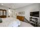 Large bedroom with carpet flooring, TV area, and ensuite bath with a view of bath area at 19700 N 76Th St # 1124, Scottsdale, AZ 85255
