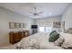 Bright bedroom featuring a comfortable bed, dresser, windows, and a ceiling fan at 19700 N 76Th St # 1124, Scottsdale, AZ 85255