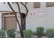 View of building number 42 with desert landscaping and garage at 19700 N 76Th St # 1124, Scottsdale, AZ 85255
