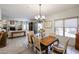 Cozy dining area open to the living room features a chandelier, lots of natural light, and comfortable seating at 19700 N 76Th St # 1124, Scottsdale, AZ 85255