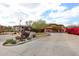 View of the gated entrance to the community with lush landscaping and the community's sign at 19700 N 76Th St # 1124, Scottsdale, AZ 85255