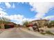 View of the gated entrance to the community with lush landscaping and the community's sign at 19700 N 76Th St # 1124, Scottsdale, AZ 85255