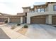 Exterior shot of townhome featuring attached garages and desert landscaping at 19700 N 76Th St # 1124, Scottsdale, AZ 85255